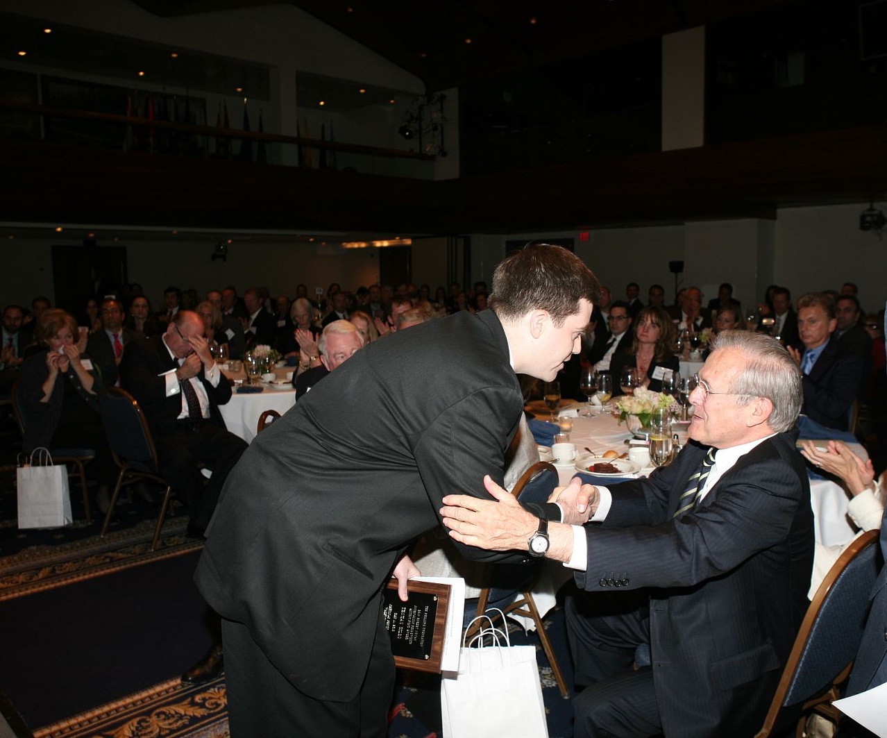 Tom Sileo shakes hands with former Secretary of Defense Donald Rumsfeld at the 2010 Novak Awards Dinner. 