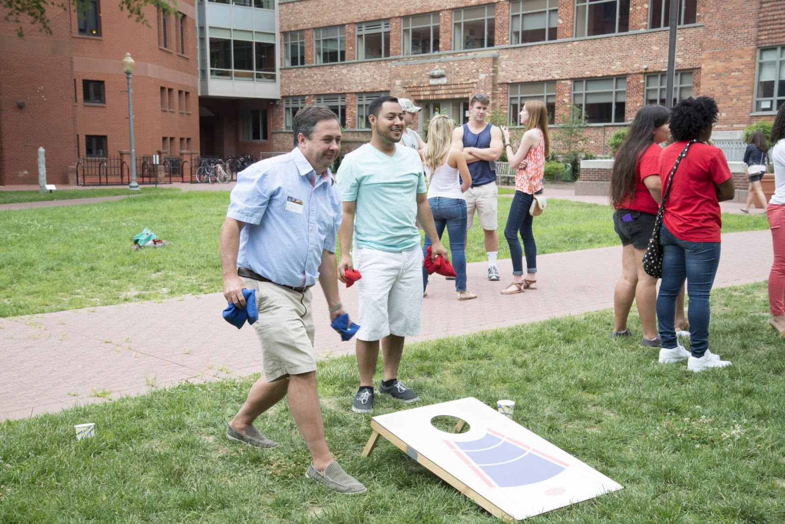 Executive Vice President Steve Slattery plays in the corn-hole tournament at the student and alumni BBQ. 