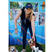 Alumna Katie Boothroyd pets some friendly canines during an advocacy event for the National Multiple Sclerosis Society, where she serves as director of communications. 
