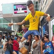 AIPE students in Hong Kong pose with a giant statue of Brazilian soccer star, Neymar