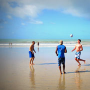 World Cup fans and locals play soccer on a beach near Natal, Brazil, where alumna Molly Muilenburg and her fiance stayed during the games. 