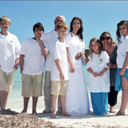 Malone poses with one of the many families she’s planned weddings for as owner of Weddings in Vieques.