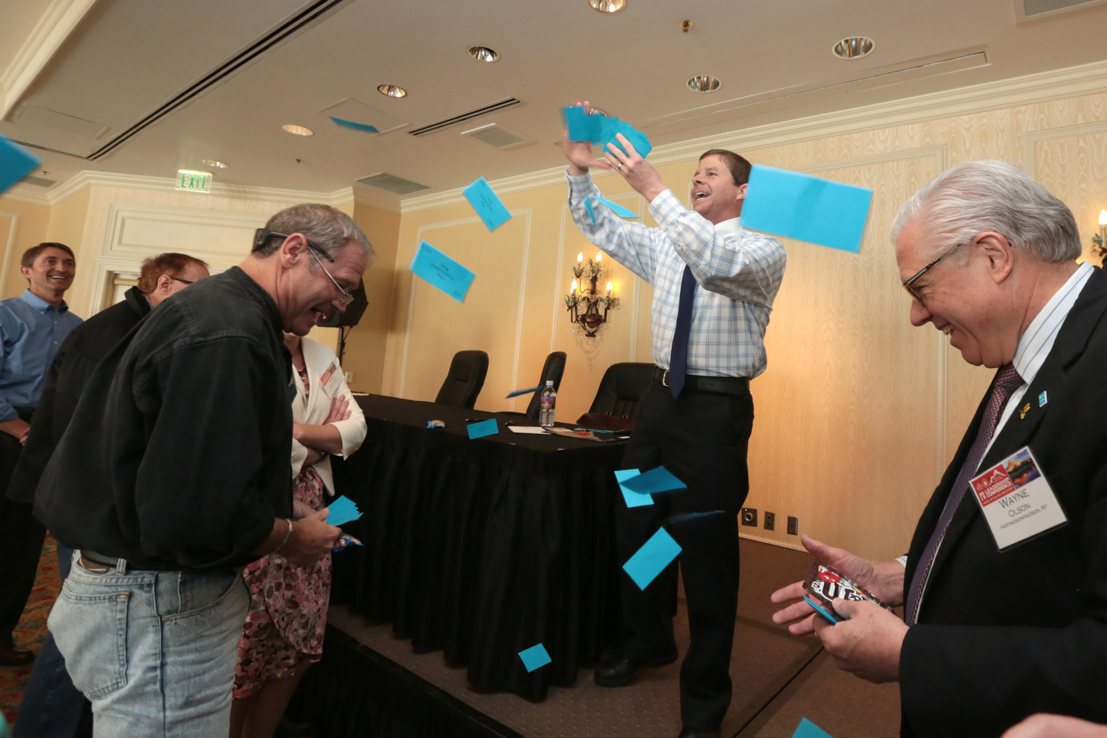 FTE Teacher Tom Rooney throws out a handful of "classroom bucks" during the conference's "Inside the Classroom" panel. Rooney showed how he uses this hands-on activity to help young students understand foreign exchange rates and world markets.