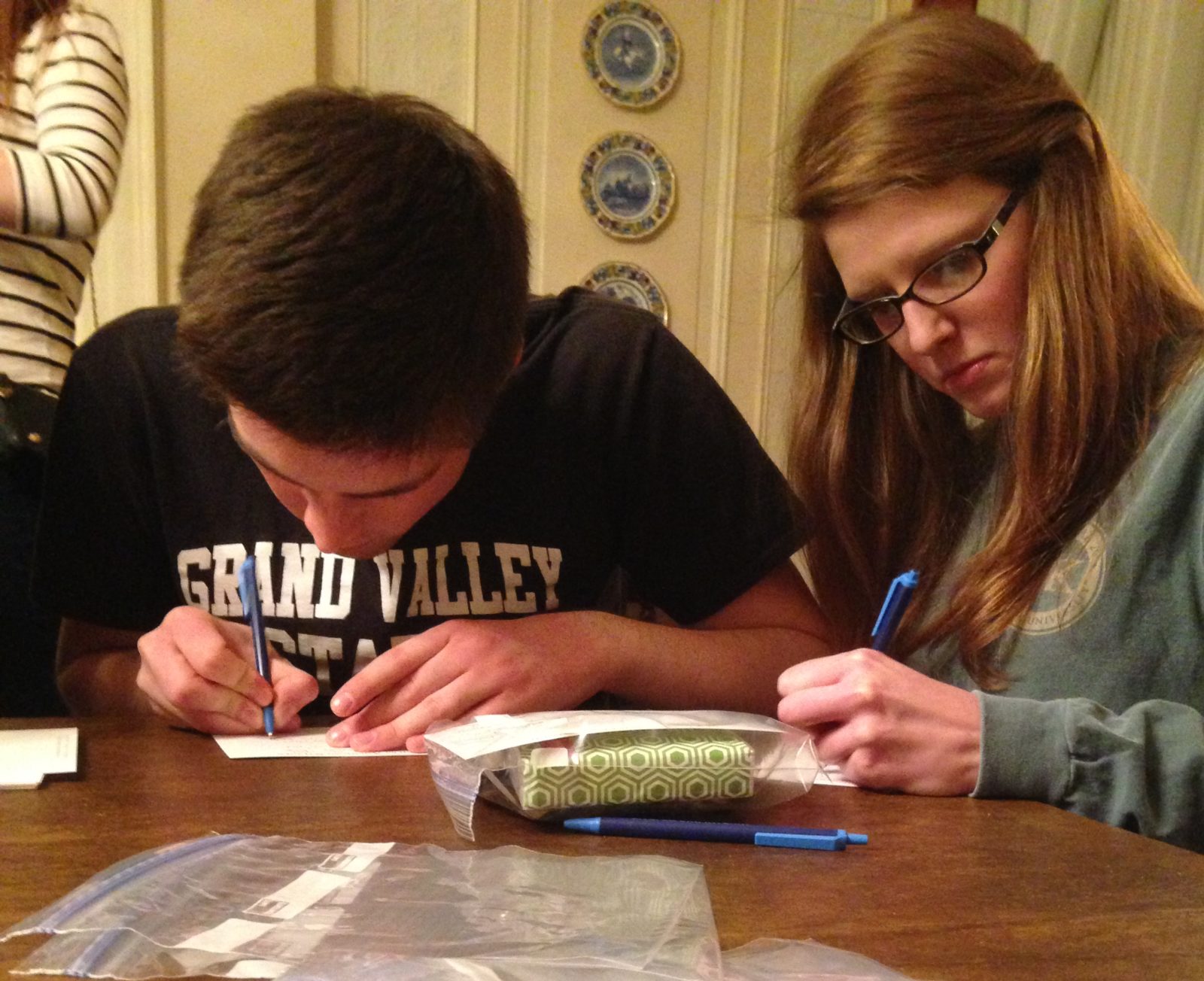 Matt Bogden (CSS 14) and Claire Johnson (CSS 14) write notes to American service members to include with the toiletry bags.