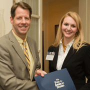 (l.-r.) President Roger Ream (E 76) presents 2009 Fellow Caroline Dierker (B 05) with her certificate. Dierker reflected on the past year during her remarks at the graduation ceremony.