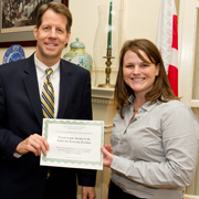 2010 Fellow Katie Fourmy (P 06) receives her graduation certificate from TFAS President Roger Ream (E 76).