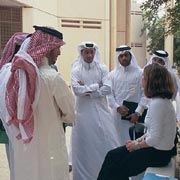 King talks with students of the University of Qatar before conducting an interview about their views on the educational reforms that were being implemented. She also talked to men and women about how they felt about the war in Iraq and having the American military in Qatar.