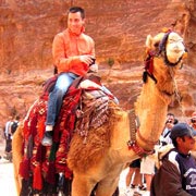 Eric Kowalski (ICPES 97, IIPES 98) rides a camel during a trip to the ancient city of Petra in Jordan.