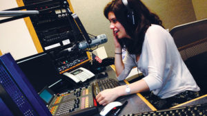 A TFAS student practices radio broadcasting at her journalism and communications D.C. summer internship.